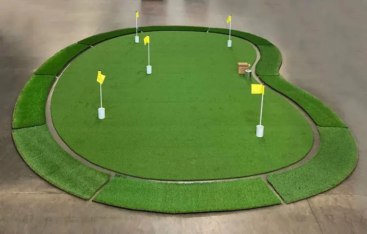 Putting green kit laid out with flags